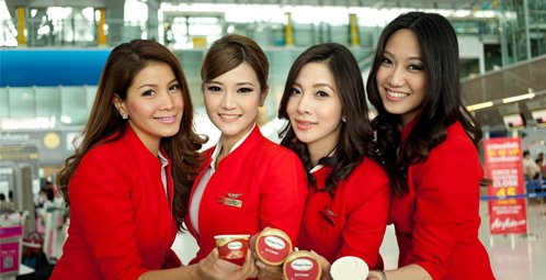 AirAsia's beautiful flight attendants present the airline's latest in-flight offering "Haagen-Dazs ice cream",